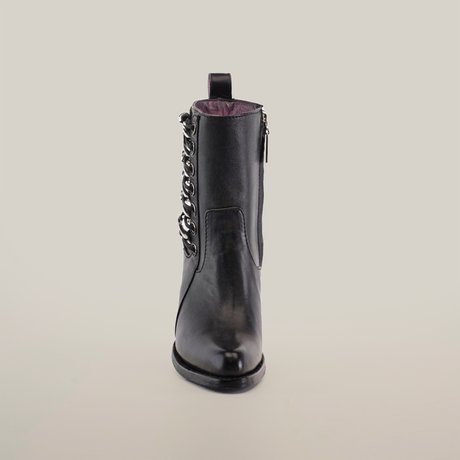 The Francia Rings Bootie Black - J Toe from the Platinum Collection exudes elegance with a decorative chain detail and zipper closure. Handcrafted by expert bootmakers, this black leather ankle boot is lined with rich dark purple, embodying luxury against a crisp white background.