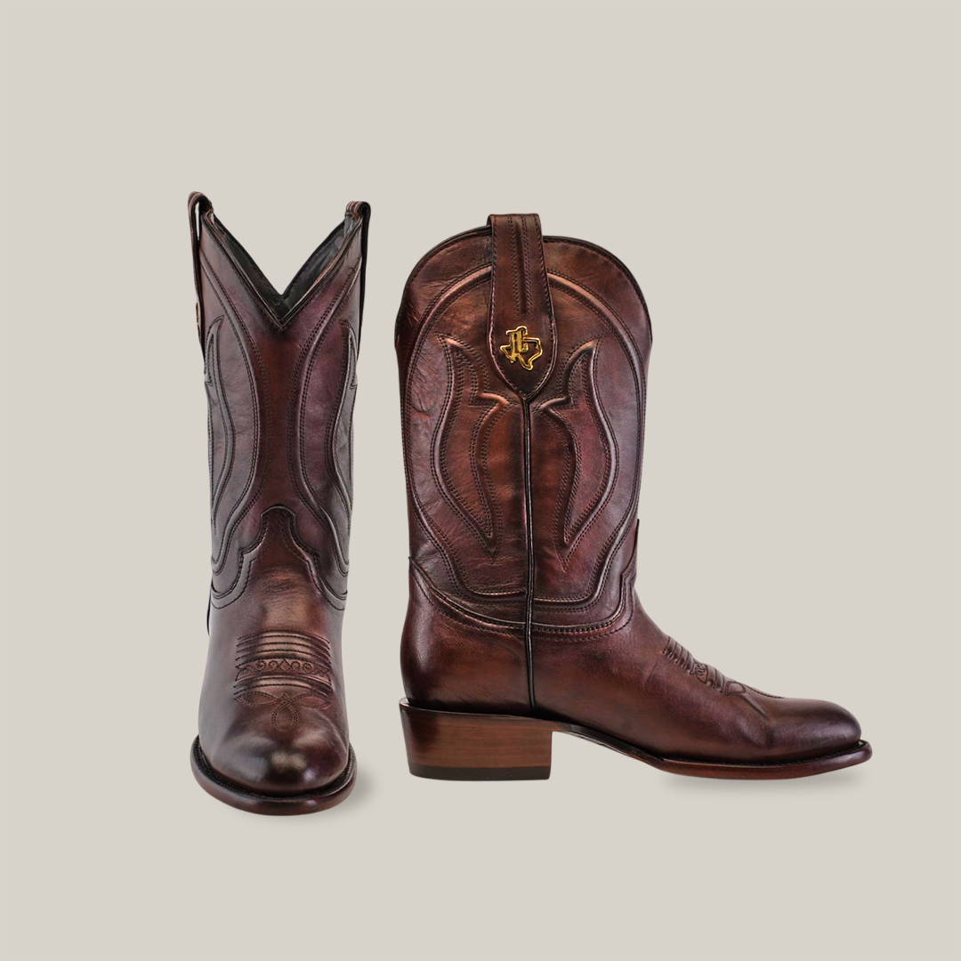 The Western - Platinum - Brown - Roper Toe boots stand on a white background, with the left one slightly tilted forward. Decorative stitching graces the shafts and toes, capturing the classic cowboy style.