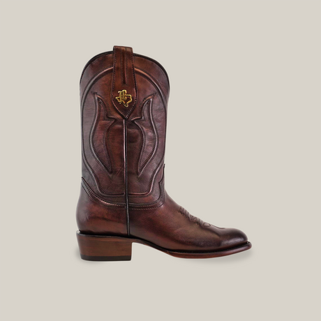 A single Western - Platinum - Brown - Roper Toe boot, crafted from leather and featuring decorative stitching with a gold emblem, sports a low heel and slightly pointed toe on a plain white background.