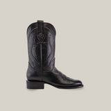 Introducing the Western - Platinum - Black - Roper Toe cowboy boot, featuring intricate stitching and a decorative emblem on the tall shaft. This elegant piece from the Platinum Collection has a low heel and slightly pointed toe, showcased against a plain white background.