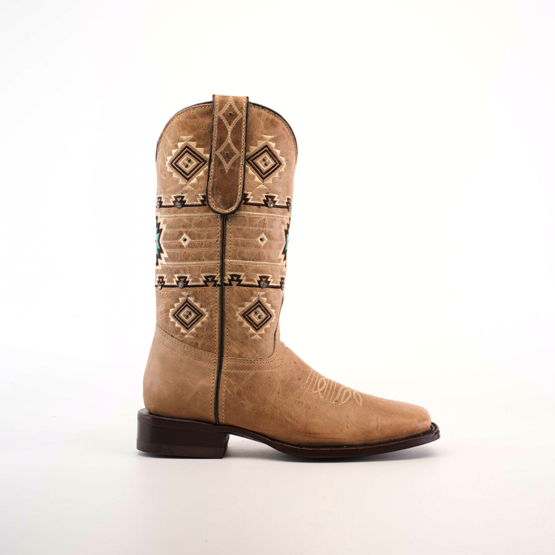 The Palles Aztec Stitch Fawn boot features intricate Aztec-inspired stitching in brown and black on a tan short shaft. It has a classic western style with a square toe, genuine leather sole, and is displayed against a plain white background.