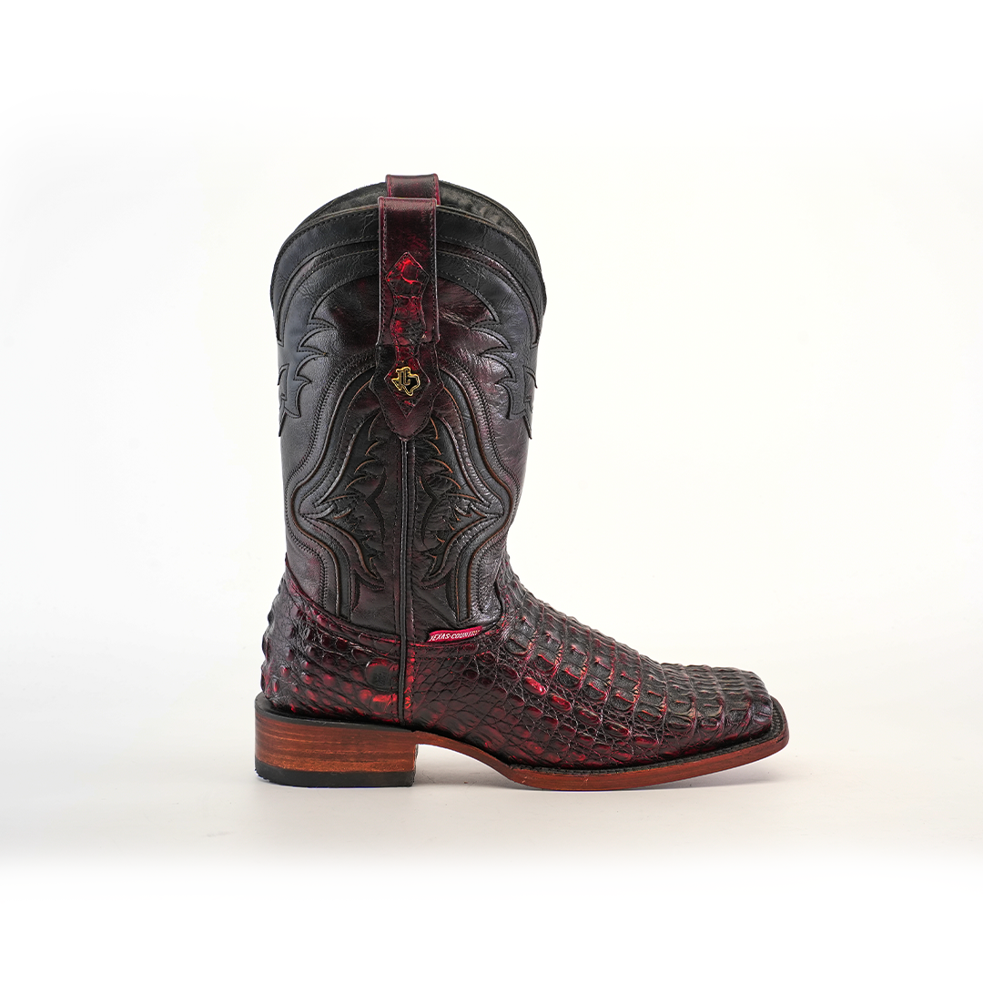 The Exotic Caiman Hornback Black Cherry Rodeo Toe boot blends tradition and style with dark red and black leather, detailed stitching, a rugged design, wooden heel with rubber sole, and decorative elements on the shaft and toe reminiscent of classic craftsmanship.