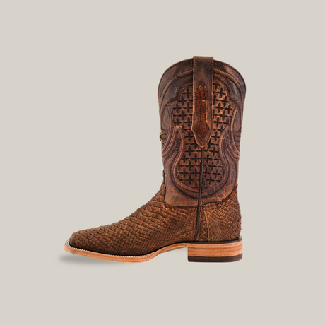 Side view of a single Exotic Python - Tamarindo cowboy boot in brown, showcasing artisan craftsmanship and textured patterns on a plain background. Made from Python Leather, it features a square toe and stacked heel.