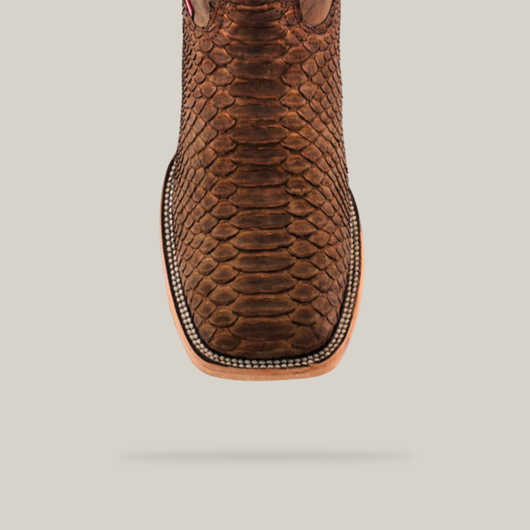 Top view of the Exotic Python - Tamarindo boot highlighting artisan craftsmanship with a square toe and textured python-like pattern, all set against a plain light gray background.