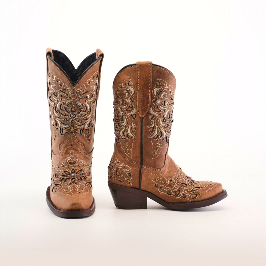 The Kiara Crystals Fawn - Snip Toe boots feature a brown color with intricate floral embroidery on a white background. Crafted from premium leather and adorned with decorative stitching, these boots offer a stylish and rustic look.