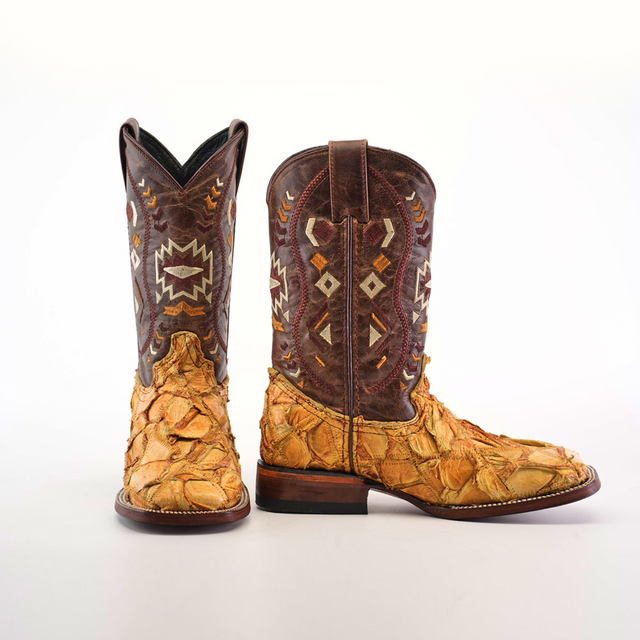 The Exotic Pirarucu Fish Patchwork Honey Square Toe boots feature textured, patterned leather with a brown and tan patchwork design, geometric designs on the shafts in white, yellow, and brown, and a uniquely rough texture inspired by pirarucu fish on the feet.