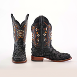 These Exotic Pirarucu Fish Patchwork boots in matte black feature a square toe, authentic leather finish, and colorful geometric embroidery in orange, white, and brown. They have a wooden heel and are showcased against a white background.