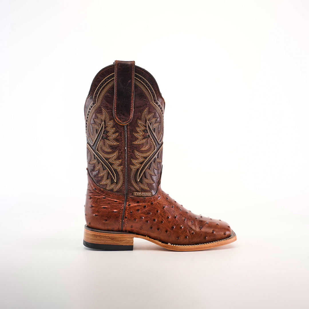 The Karoo Ostrich Print Chocolate Square Toe boot, crafted from premium materials, features a single brown cowboy boot with decorative stitching and a unique texture. Displayed in profile against a neutral background, it highlights the designs elegance.