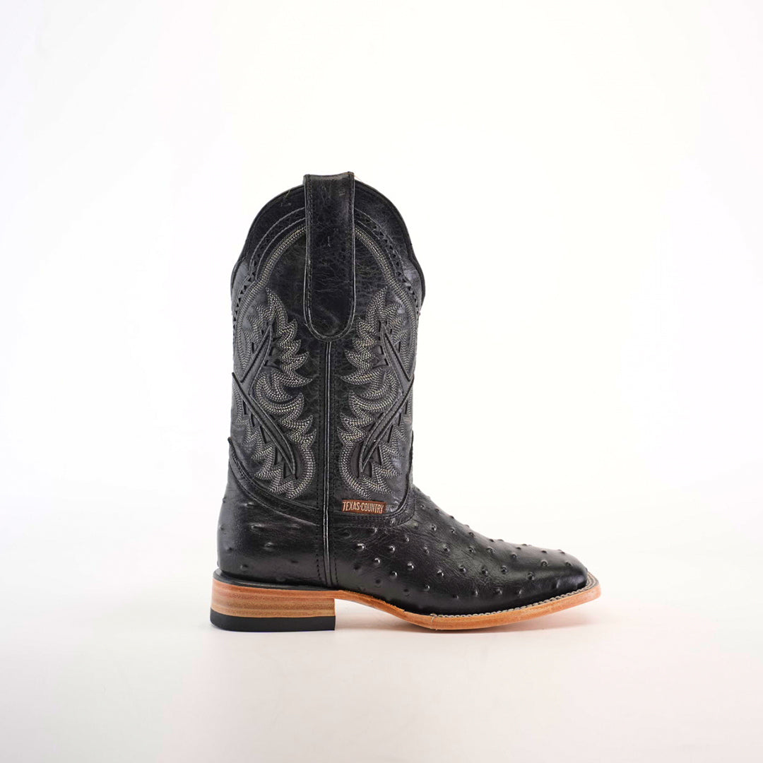 Side view of the Karoo Ostrich Print Black Square Toe cowboy boot, showcasing intricate embroidery on the shaft, textured designs with an ostrich print on the lower part, a light brown sole, small heel, and modern square toe against a plain white background.