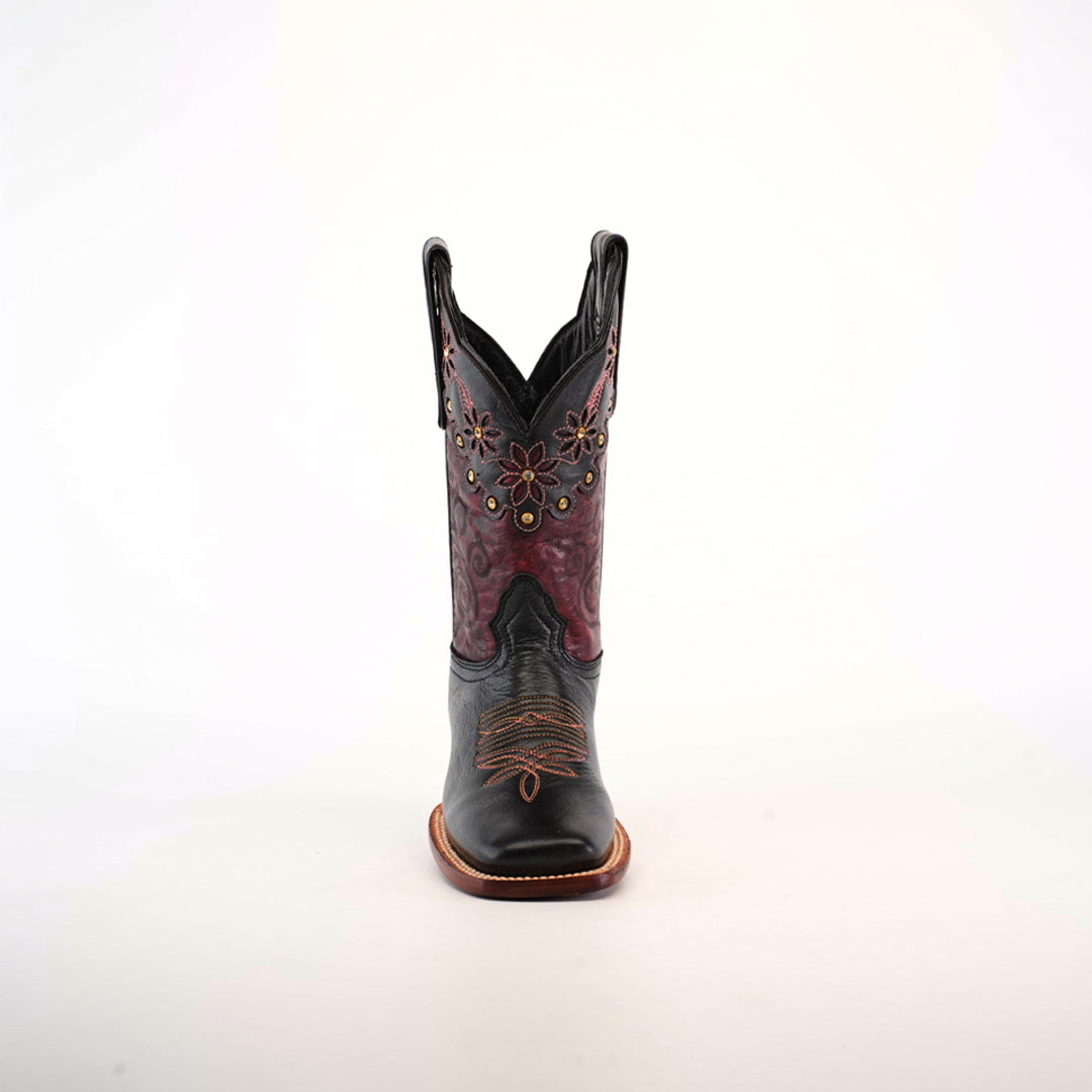 The Grecas Black boot exudes Western sophistication with intricate floral embroidery, handcrafted leather, and a signature square toe. Displayed against a plain white background, it captures timeless elegance in black and maroon.