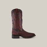 Set against a plain gray background, the Brown Elephant Laser & Embroidery boot (CU848) showcases intricate stitching, laser-engraved details, and a brown pull strap. It features subtle patterns and a square toe.