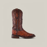 The Moroni Chestnut Ostrich Laser & Embroidery CU457 cowboy boot showcases intricate laser and embroidery designs on the shaft, set against a plain light background. Crafted from premium ostrich leather, this single brown boot features a low heel and square toe for timeless style and comfort.