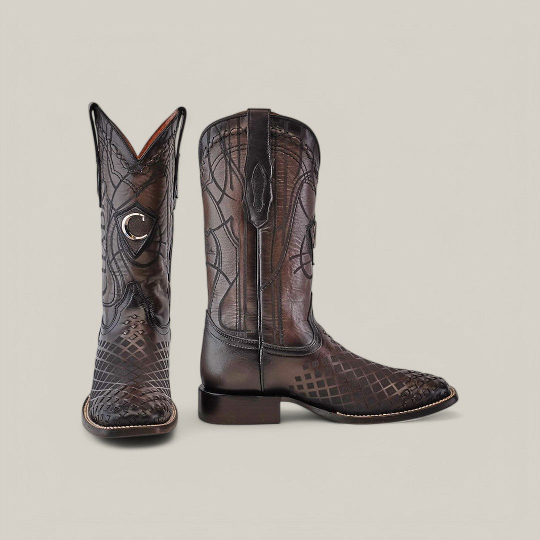 The Over Black Laser & Embroidery & Woven - Square Toe - CU676 boots feature intricate designs with a textured pattern and elegant embroidery, presented in a display showing one boot facing forward and the other to the side against a simple light backdrop.