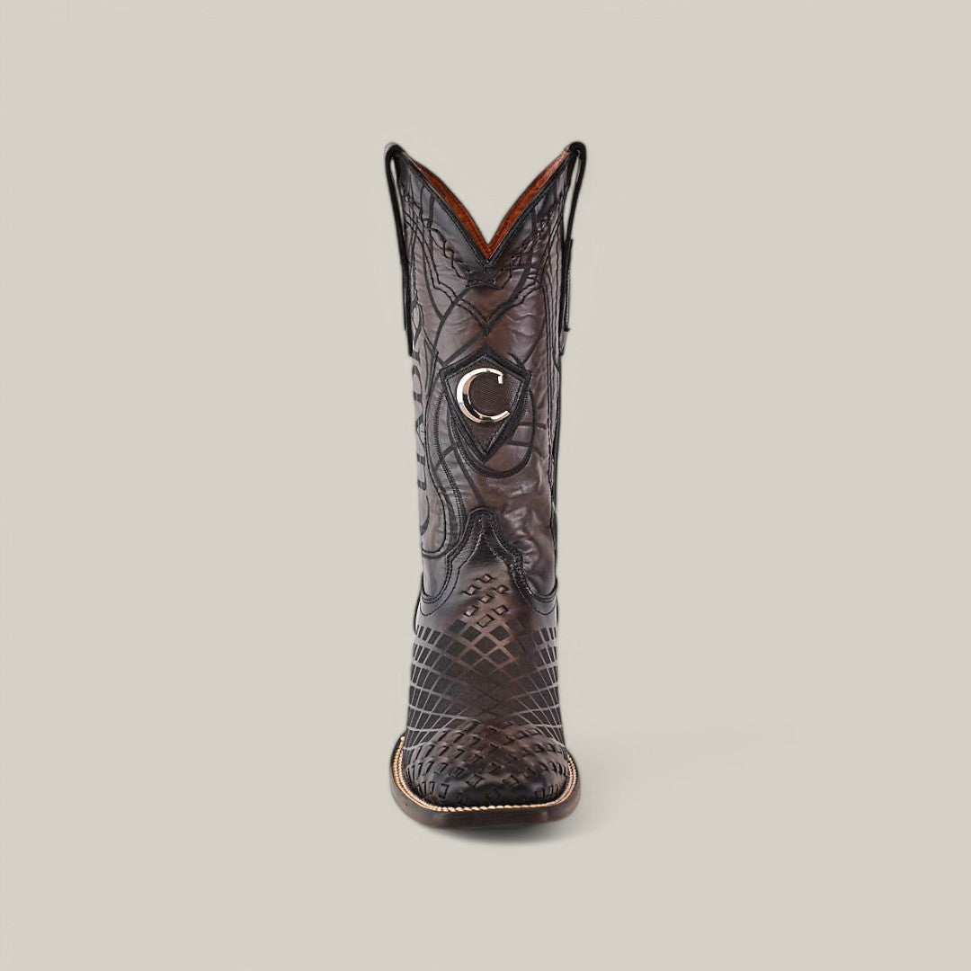 A single brown cowboy boot with intricate stitching and a shiny, textured pattern is featured. It has a stylish crescent-shaped emblem near the top, similar to Cuadras Over Black Laser & Embroidery & Woven Square Toe - CU676, set against a plain beige background.