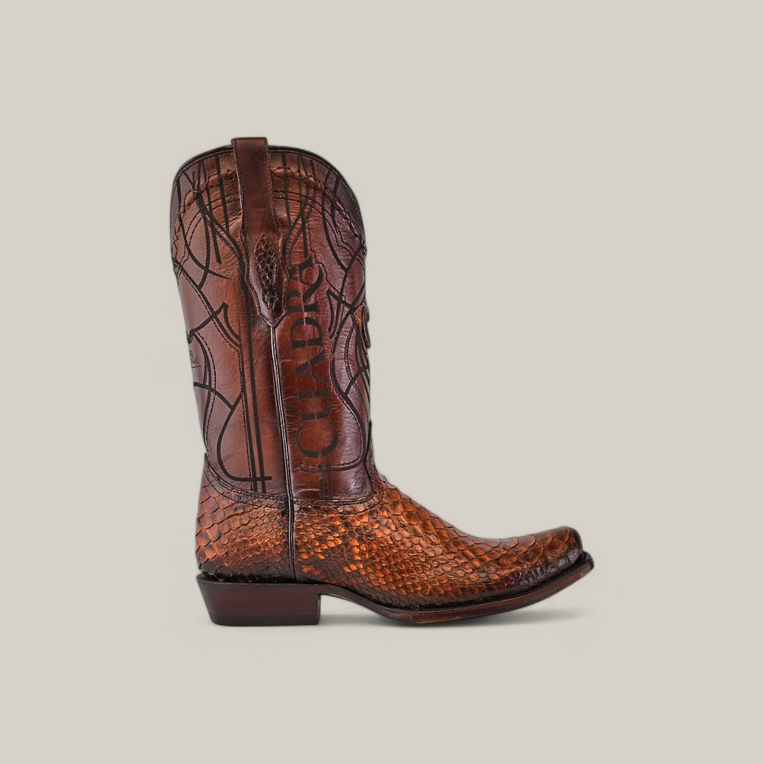 The Over Brown Python Laser & Embroidery - Narrow Square Toe - CU401 boot features intricate swirl patterns and textured, Python leather detailing with a slight heel, all highlighted against a plain light gray background.