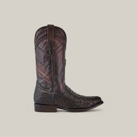 A single black cowboy boot, featuring intricate laser and woven detailing on the shaft and foot, reminiscent of Cuadras Black Ostrich Laser & Woven - Round Toe - CU554 boots, set against a plain beige background.