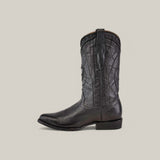 The Black Deer Laser & Embroidery - Round Toe - CU682 is a black cowboy boot crafted from textured deer leather, featuring intricate stitching, laser-engraved shaft design, pointed toe, and low heel. Its set against a beige background, blending rugged elegance with modern craftsmanship.