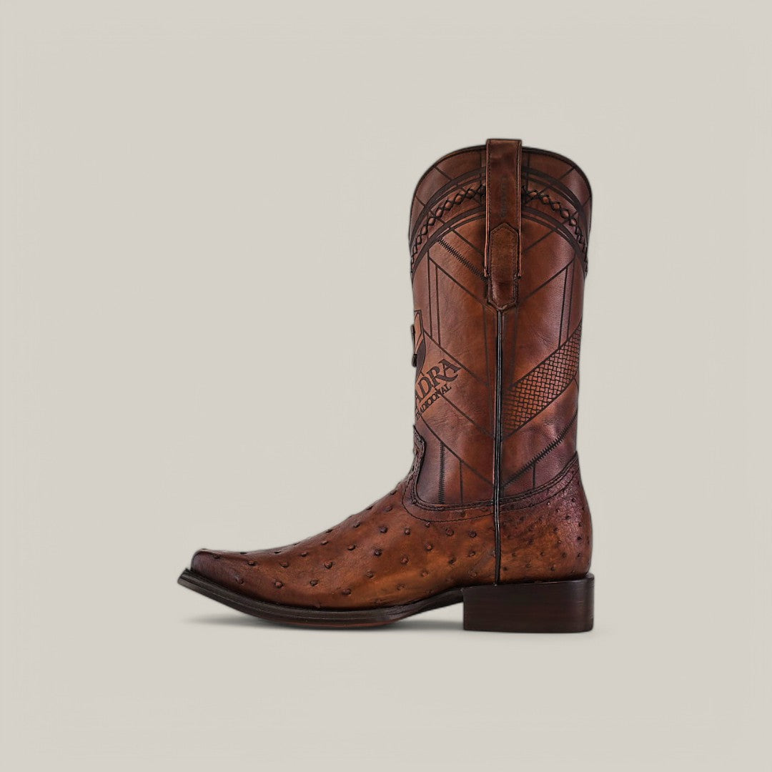 The Arauco Chocolate Ostrich Laser & Woven - Narrow Square Toe - CU597 is a brown leather cowboy boot with intricate stitched patterns on the shaft, decorative ostrich-like textures, and a low wooden heel.