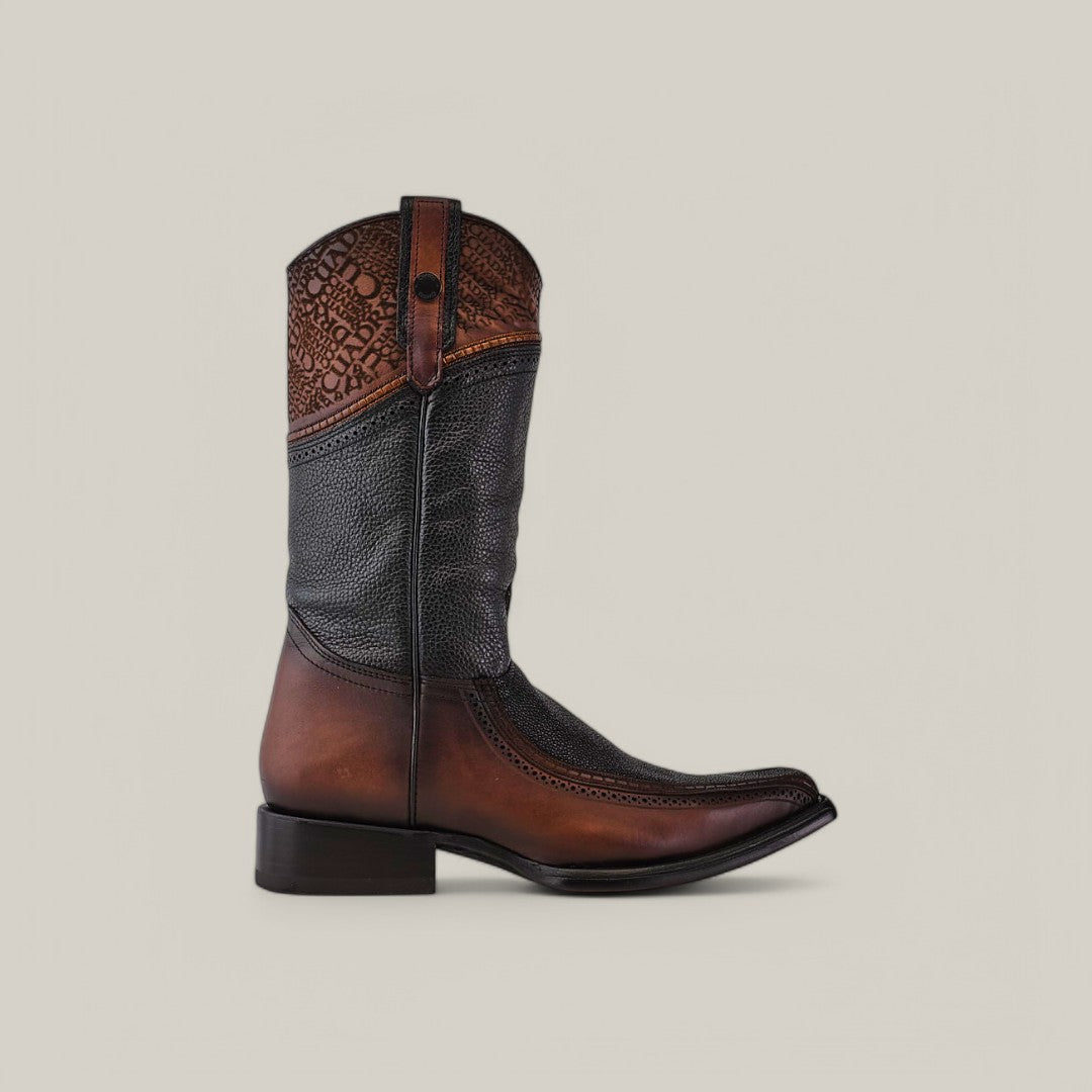 The Black Stingray Laser - Narrow Square Toe - CU628 cowboy boot features a two-tone design with exotic dark brown leather on the lower part and lighter brown upper with detailed laser-engraving. It includes a low heel and pointed toe, all set against a plain light gray background.