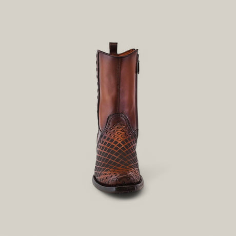 The Over Maple Laser & Woven boot (CU674) is a single brown leather piece with a narrow square toe, intricate geometric stitching, and laser-etched design. It features a side zipper and back pull tab, displayed elegantly on a light gray background.