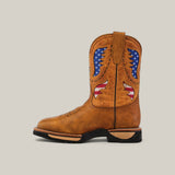 The Taurus Honey Soft Toe - E6189 is a durable brown cowboy boot with decorative American flag cutouts, featuring a tan upper and a strong black sole and heel for both style and reliability.