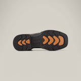 The image displays the underside of the Taurus Honey Composite Toe - E6189 boot, featuring a black outsole with orange chevron-shaped grips. This unique tread pattern enhances traction and durability, while the plain background accentuates the boots robust design.