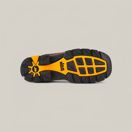 The image features the rugged tread pattern of the Amazonas Dark Brown Composite Toe - E6256. The predominantly black, waterproof sole has orange accents and a sun-like design near the heel, with SRX prominently displayed at its center, highlighting durability.