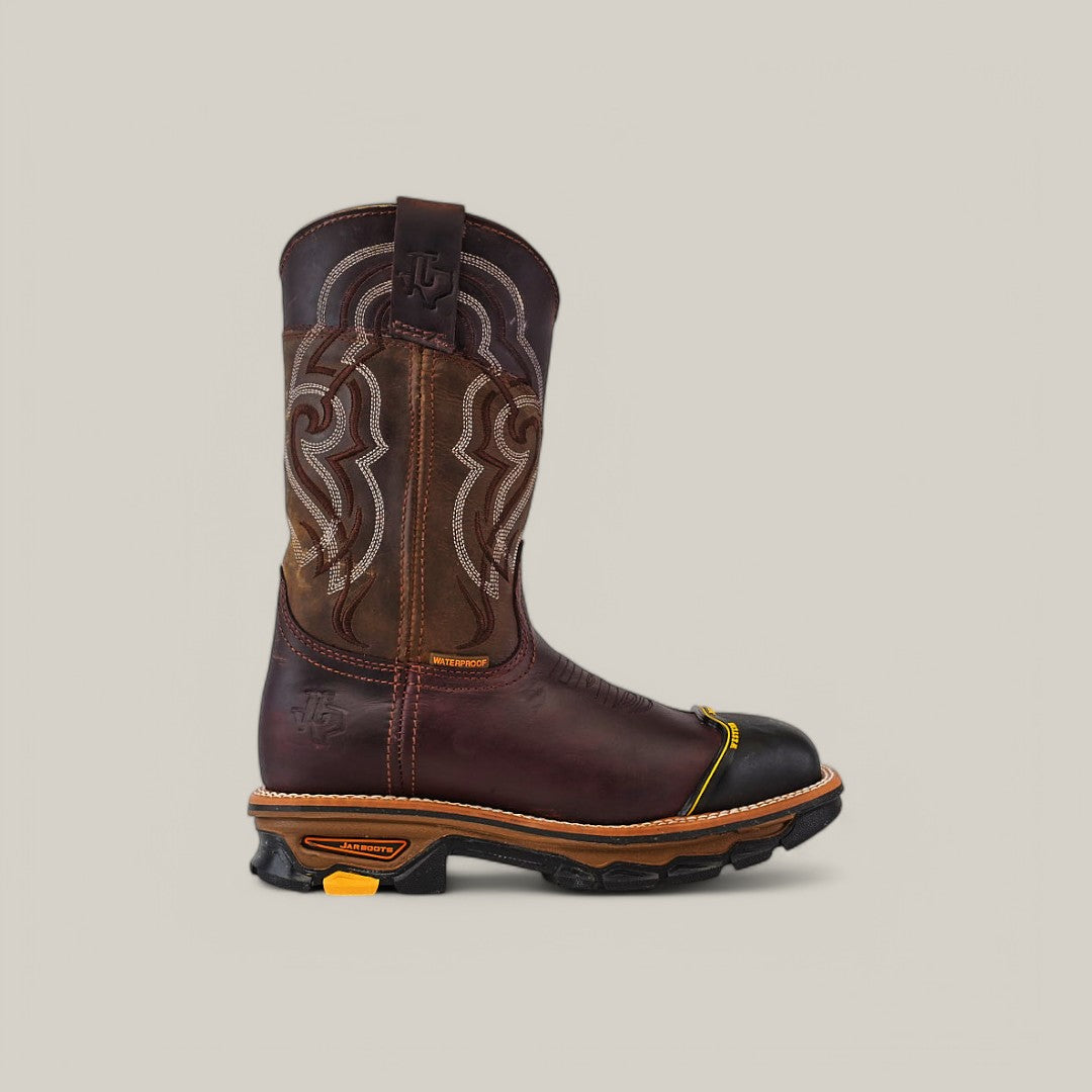 The Amazonas Chocolate Soft Toe - E6258 features a single cowboy boot with a brown leather upper, decorative stitching, and a reinforced black toe. It embodies the rugged durability of Texas Country Work Boots, featuring a robust sole with yellow accents and pull tabs at the top against a plain background.