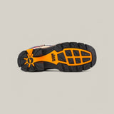 The image displays the durable sole of the Aventajado Penac Soft Toe - E6282 sneaker, featuring a rugged, multi-patterned tread. The predominantly black design with orange accents and the SIX logo near the heel is reminiscent of Texas Country Work Boots, set against a plain light gray background.