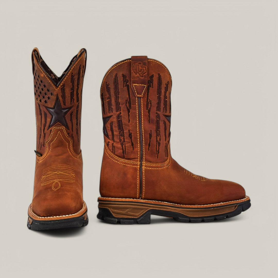 The Amazonas Honey Composite Toe - E6259 features a boot in brown with black star and flag designs on the shaft. One boot stands upright, revealing side patterns, while the other is angled to display the front and durable toe stitching.