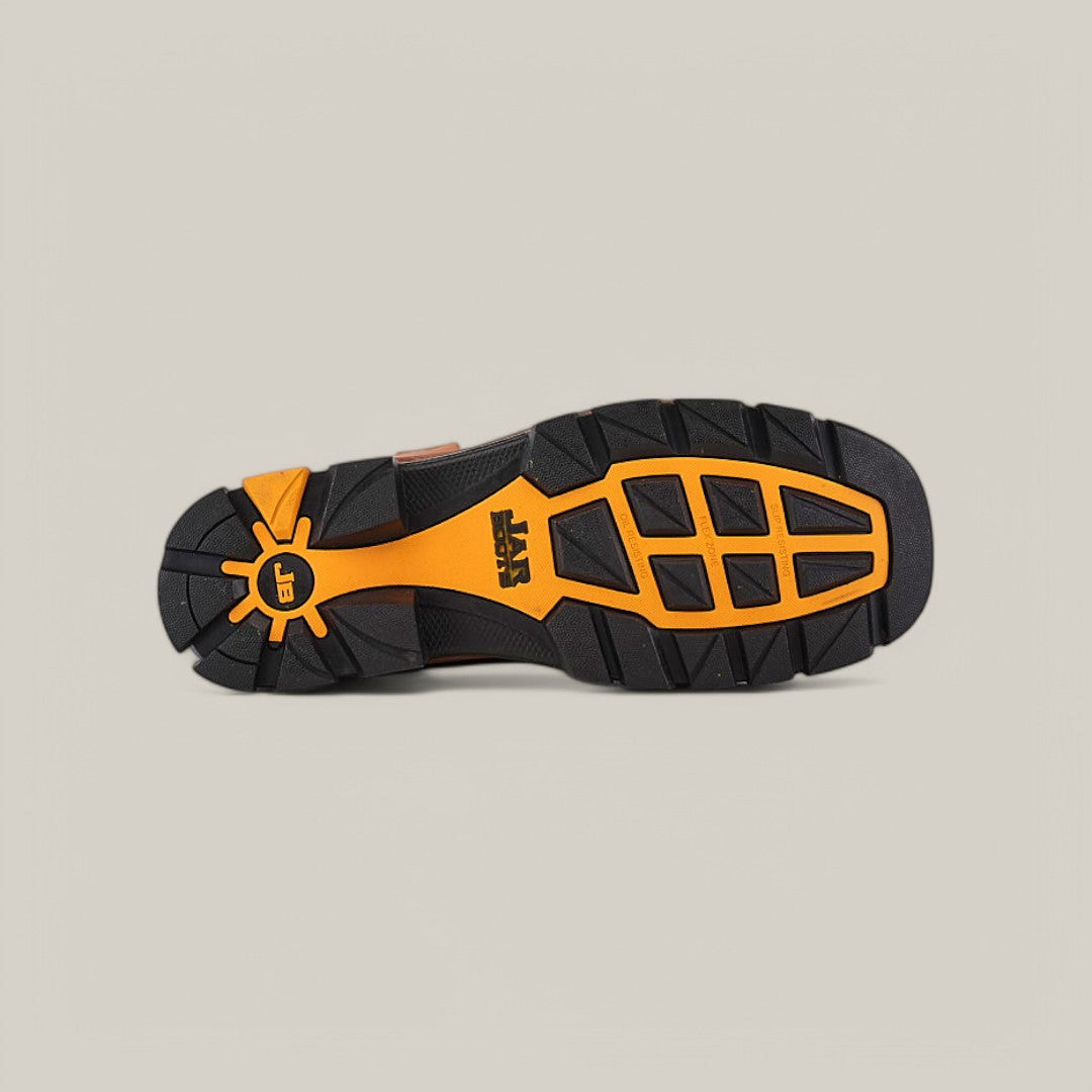 The image displays the sole of the Amazonas Honey Composite Toe - E6002, resembling Texas Country Work Boots with a black and orange rugged tread pattern. A central logo emphasizes its durability on various terrains, set against a plain light beige background.