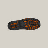 The image displays the Golden Ateus Composite Toe - E6016 sole against a plain background. It features a black base with orange zigzag and block patterns for traction, designed for durability to handle diverse terrains.