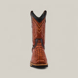 Front view of the Alligator Print Cogñac Soft Toe - E6022 cowboy boot featuring detailed stitching and a textured pattern like alligator skin. It has a black upper trim, wooden sole, and is set against a plain light gray background, showcasing rugged durability.