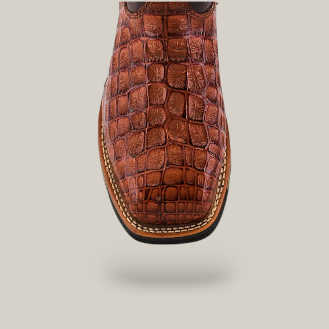 Close-up of the Alligator Print Cogñac Soft Toe - E6022, featuring brown leather with a crocodile texture and visible stitching along the sole, set against a plain, light background.