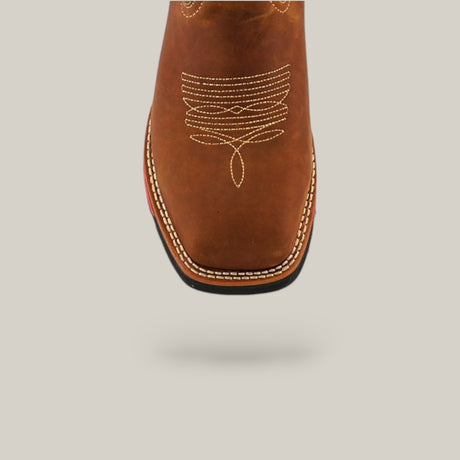 Close-up of the toe of a Texas Honey Composite Toe - E6082 boot, made of durable brown leather with intricate white stitching. The boot casts a subtle shadow on a plain background.