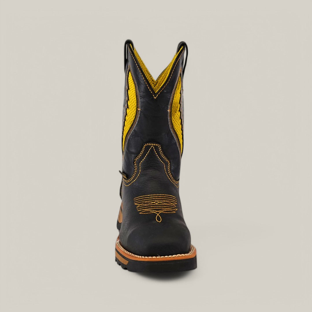 The Rhino Black Soft Toe - E6087 cowboy boot is set against a light gray backdrop. Known for its durability and comfort, this single boot features yellow stitching and decorative patterns, blending style with robust functionality.