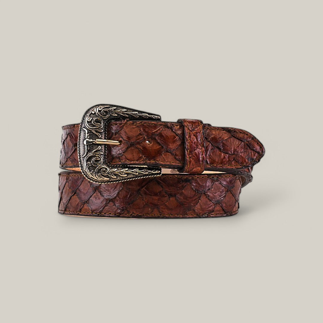 The Exotic Full Quilt Pirarucu Fish Brown Belt, featuring an ornate silver Texas buckle and a quilted texture resembling scales, is elegantly coiled on a neutral background.