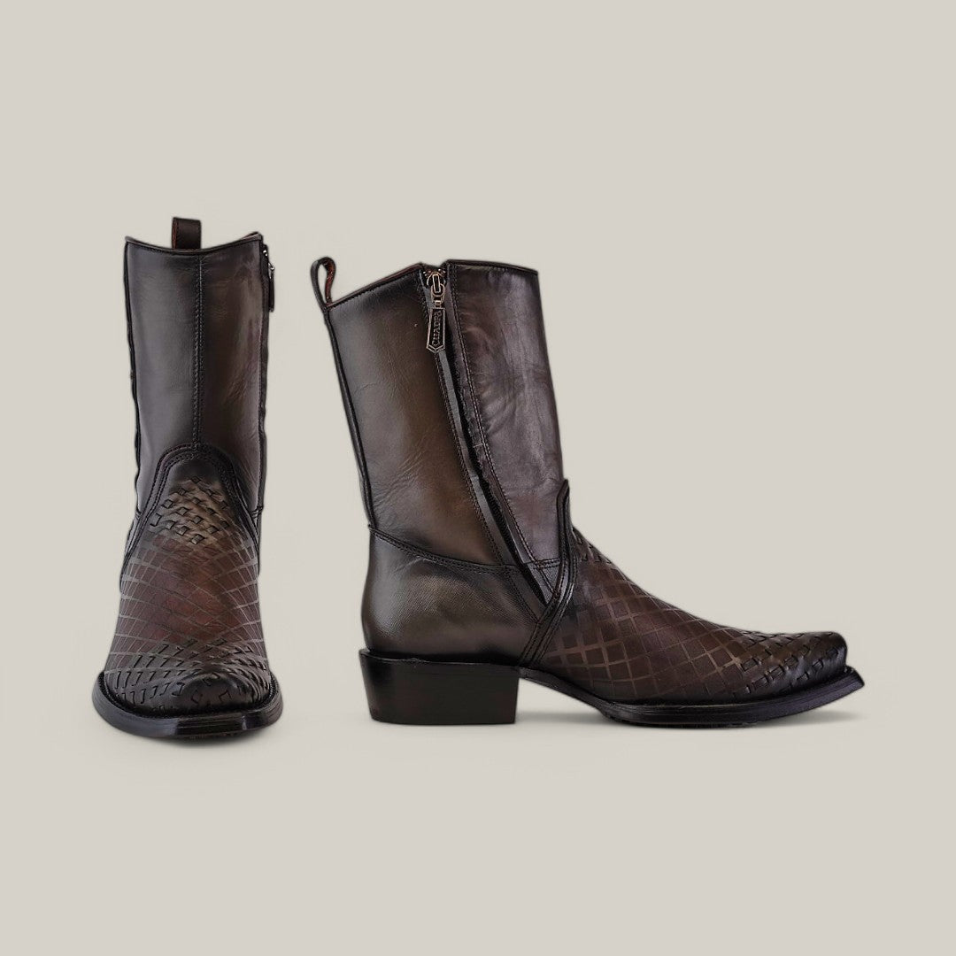 The Over Light Black Laser & Woven CU498 cowboy-style boots from Cuadra, featuring a narrow square toe and side zipper, showcase a lizard skin texture on the toe and heel. They are elegantly displayed on a neutral background, emphasizing their refined design.