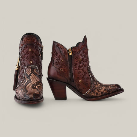 Introducing the Ximena Bootie - Python Choco from the Platinum Collection: mid-calf leather boots in dark brown, featuring floral embroidery, round toe design, side zippers with tassels, and chunky heels against a plain gray background.