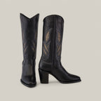 A pair of Black Embroidery - Round Toe - CU874 cowboy boots in tall black leather features decorative leaf-shaped embroidery on the shafts, with tan and grey hues against a light gray background, and chunky heels for added elegance.