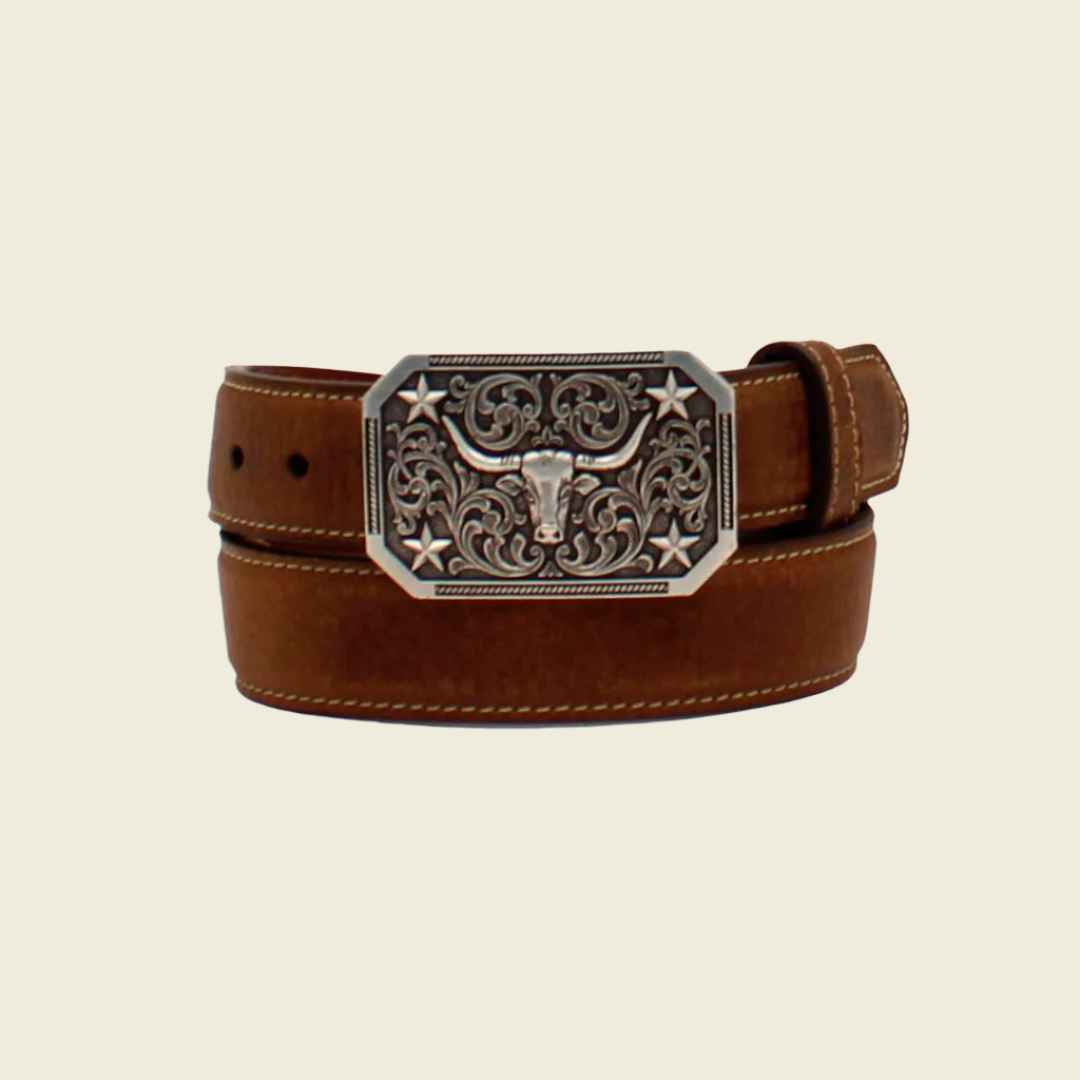 The Nocona Western Boys Belt features a brown leather design with a decorative silver buckle. The buckle showcases intricate floral engravings, a longhorn head design, star accents, and rounded corners, perfect for those seeking unique Western-inspired leather accessories.