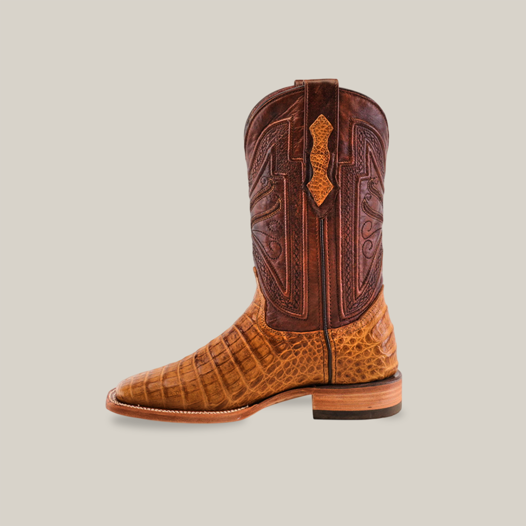 The Exotic Caiman Horn Back - Brown - Square Toe boot showcases intricate stitching on a brown genuine leather upper with a textured tan lower, set against a plain light background.