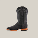 The Exotic Stingray - Black - Square Toe cowboy boot exudes Western luxury with its square toe, wooden sole, detailed stitching on the shaft, pull tab at the top, and a display on a plain light beige background.