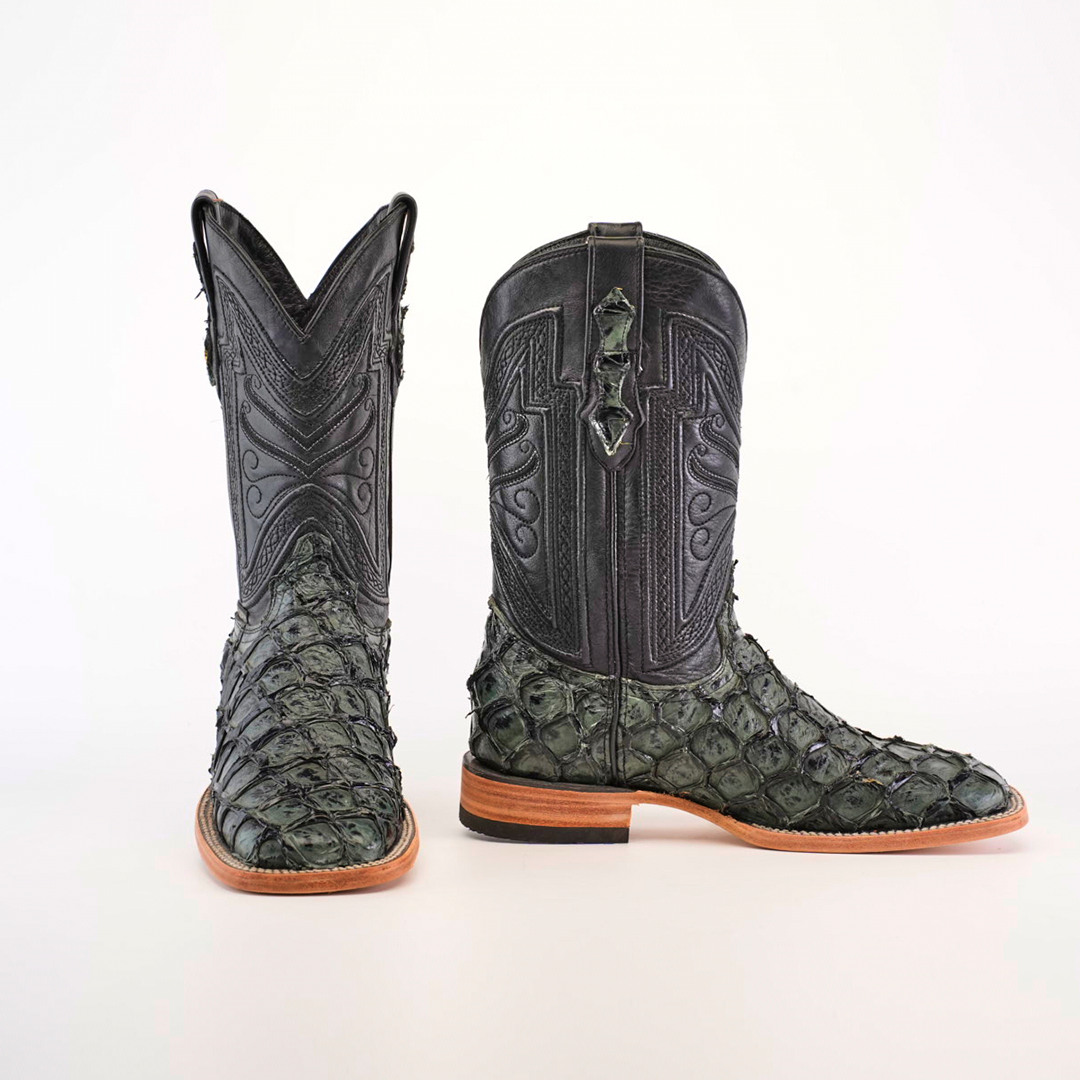 The Exotic Piraruco Fish - Charcoal boots, cherished by fashion lovers, showcase intricate stitching and greenish fish leather scales on the lower part. Featuring wooden soles and a tall, pointed shaft with decorative patterns, they contrast vividly against the plain white background.