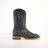 The Exotic Piraruco Fish boot in charcoal features a green and black leather design with crocodile texture and intricate shaft patterns. Ideal for fashion enthusiasts, it has a wooden sole, square toe, slight heel, and is set against a plain white background.