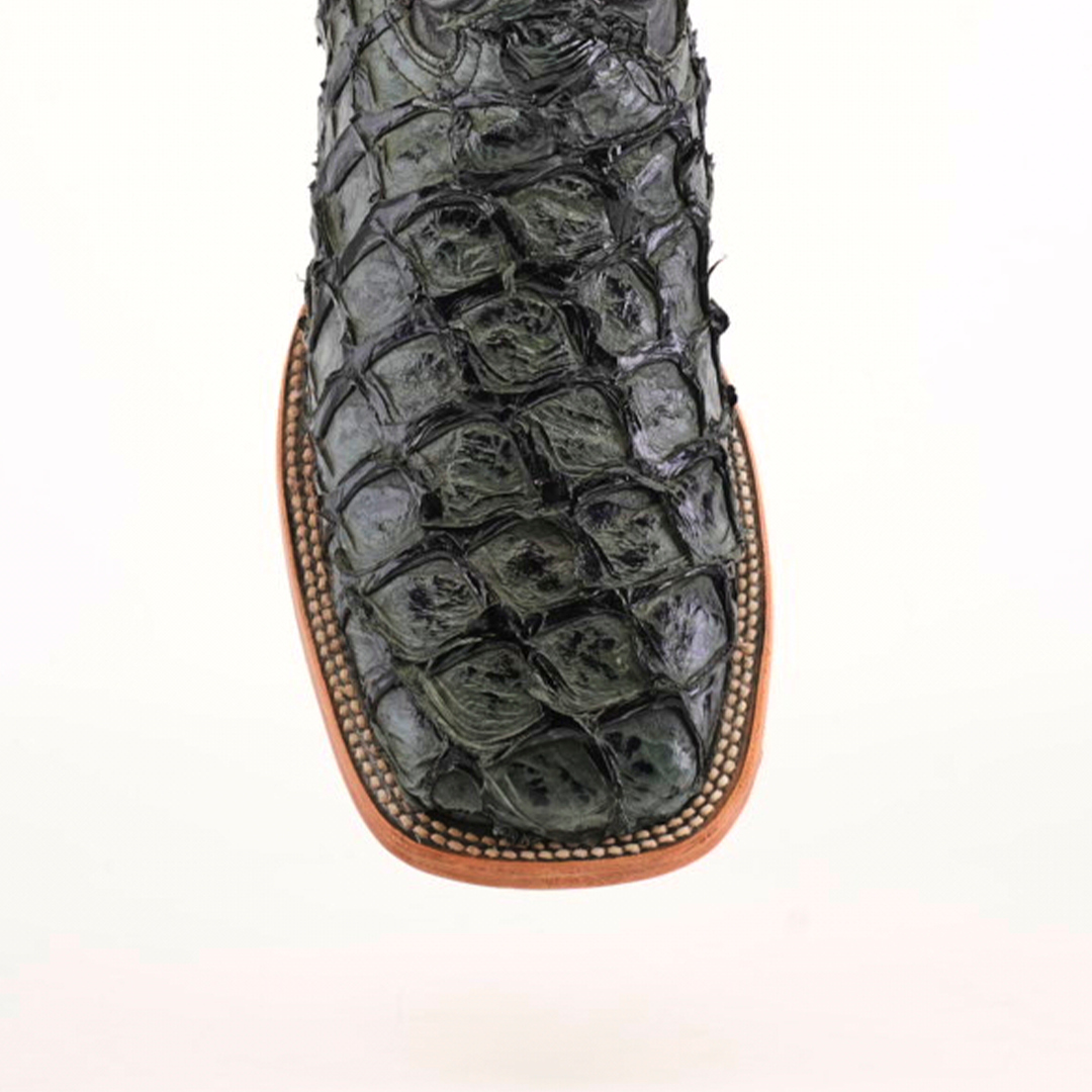 Close-up of an Exotic Piraruco Fish - Charcoal- Square Toe boot, loved by fashion enthusiasts, showcasing a glossy dark green fish leather pattern. It features a light brown sole with detailed edge stitching, set against a plain white background.