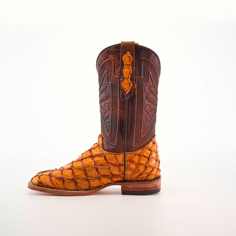 The Exotic Piraruco Fish - Brandy - Square Toe is a cowboy boot crafted in textured brown and orange leather with intricate detailing on the shaft, made from genuine fish leather, shown in profile against a plain white backdrop.