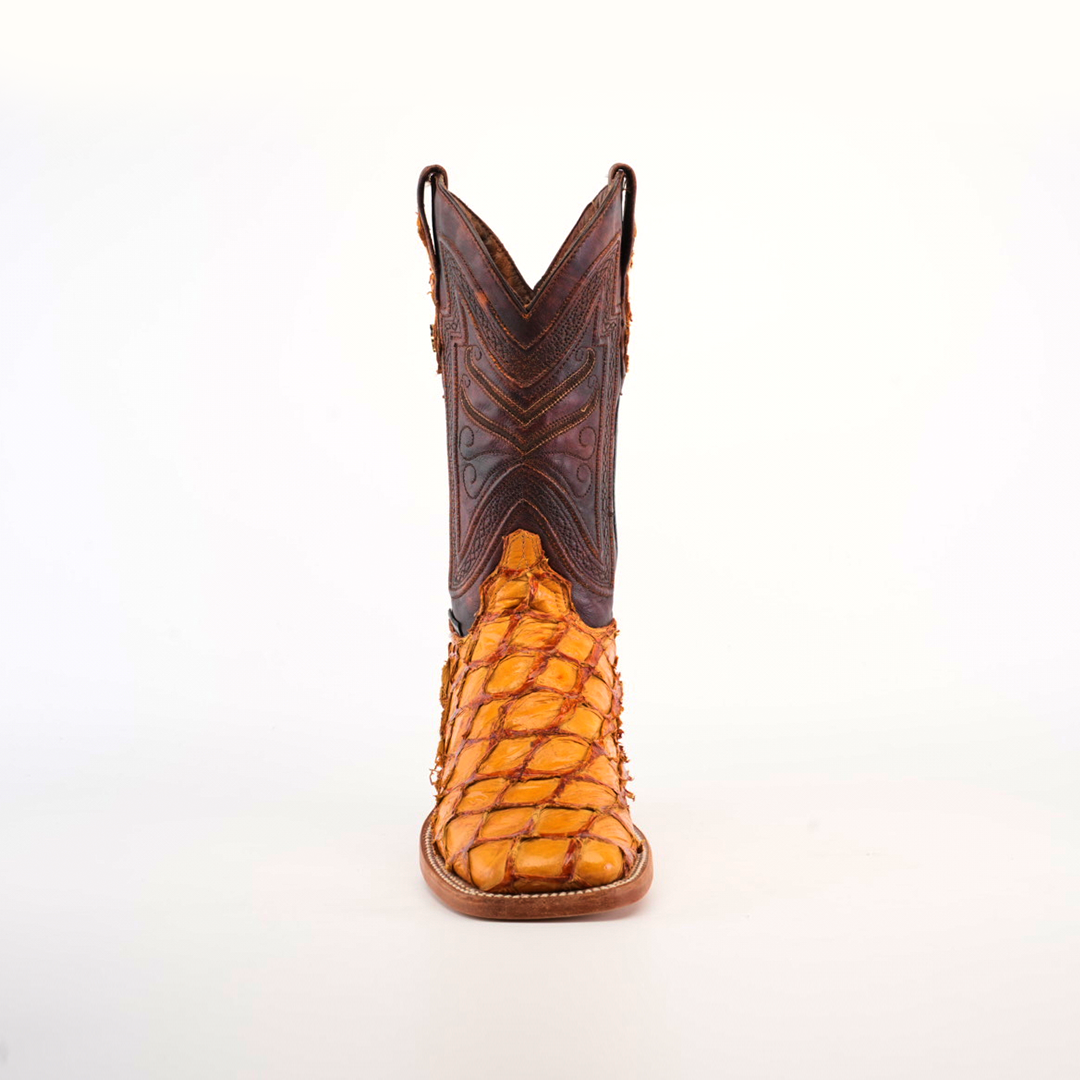 The Exotic Piraruco Fish - Brandy - Square Toe boot is made from genuine fish leather in a brown and orange texture. It stands upright on a white backdrop, showcasing intricate stitching on the upper shaft and exemplifying premium cowboy footwear.