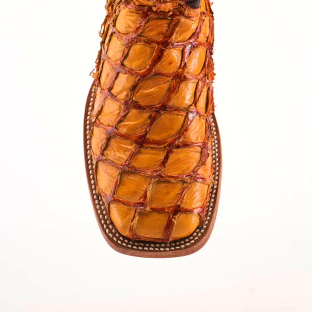 A close-up of the Exotic Piraruco Fish - Brandy shows a square-toed brown leather shoe made from genuine fish leather, featuring a textured, scale-like pattern with detailed edge stitching, set against a plain white background.