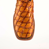 A close-up of the Exotic Piraruco Fish - Brandy shows a square-toed brown leather shoe made from genuine fish leather, featuring a textured, scale-like pattern with detailed edge stitching, set against a plain white background.